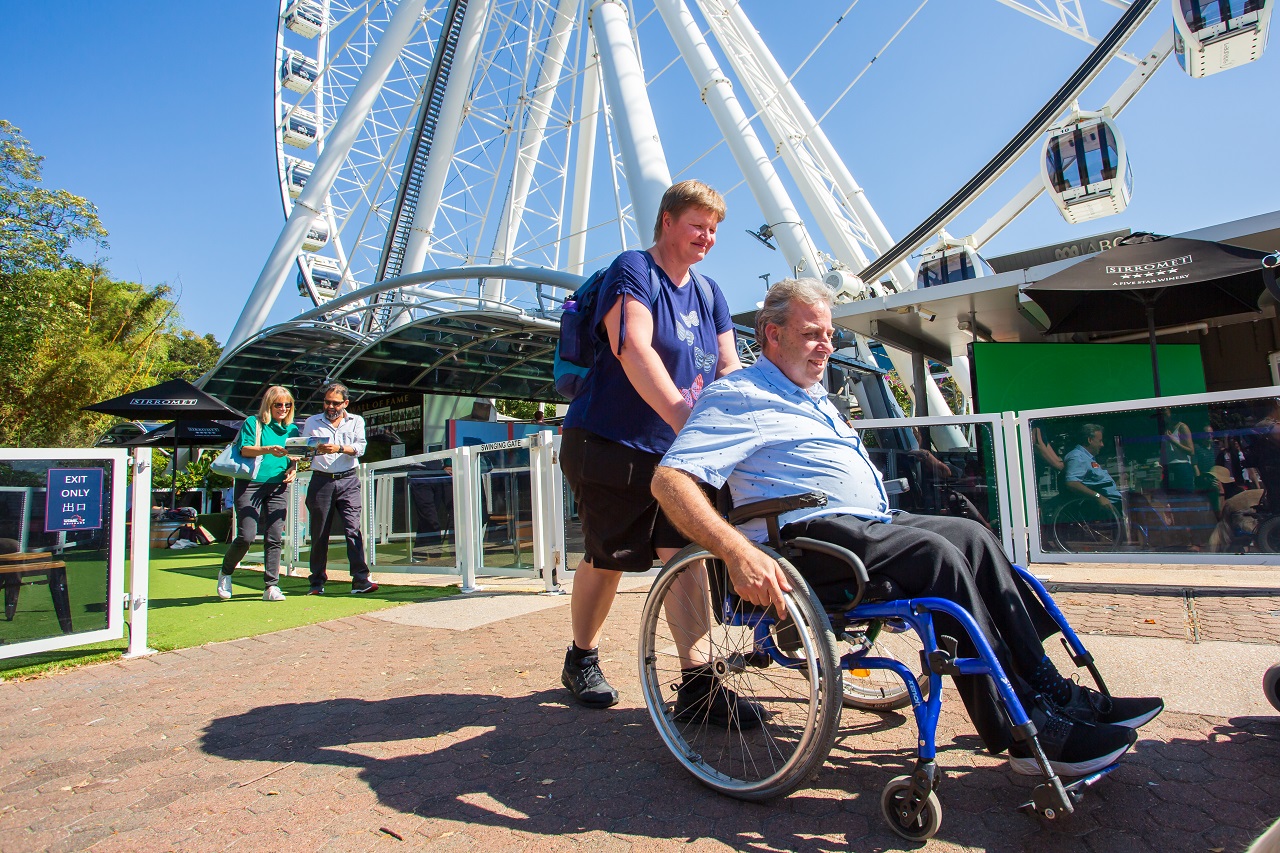 Brisbane_South Bank_Wheel of Brisbane_Accessible chinese-speaking support worker assisting an elderly with disablity in Australia