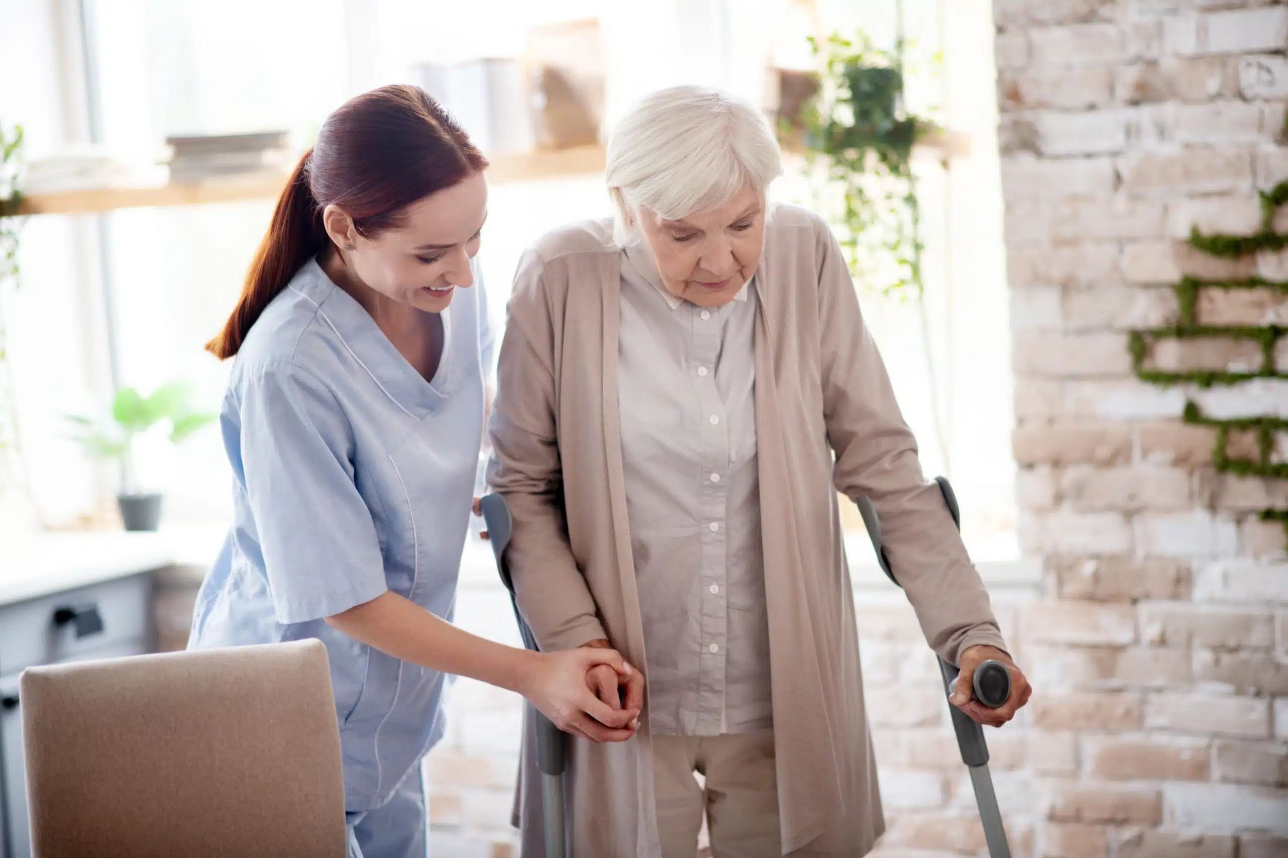 Caregiver-assisting-woman Elderly person receiving care at home from a african support worker