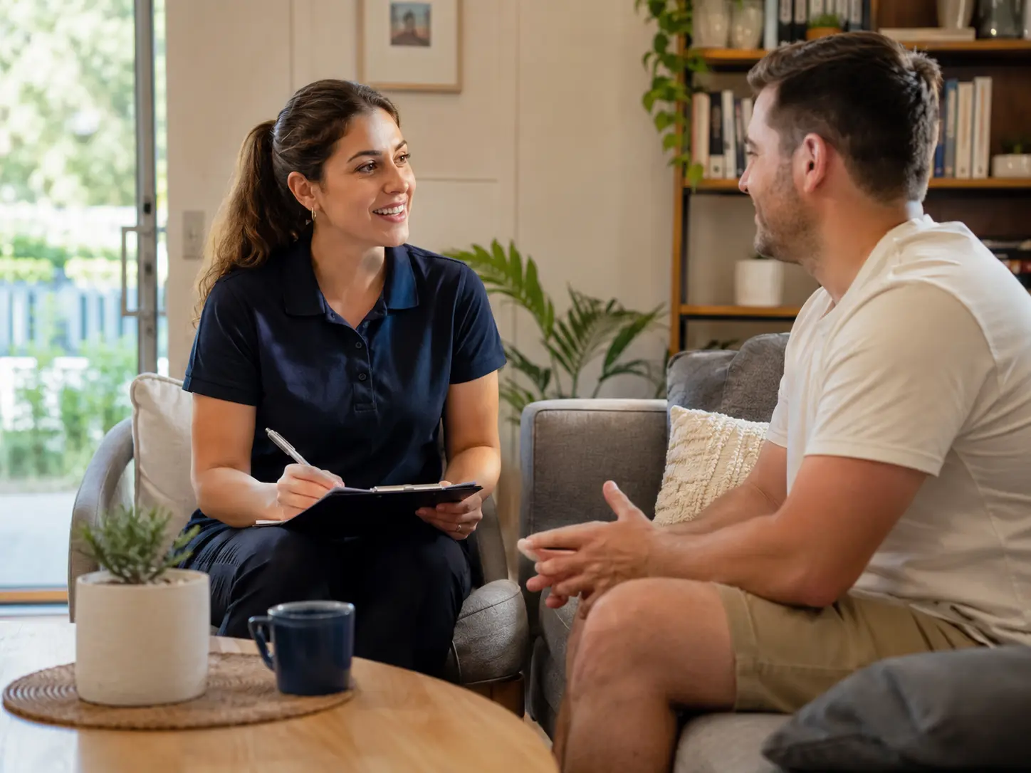 Italian speaking disability support worker discussing care needs with an NDIS participant at home